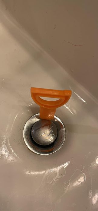 Before image showing the drain snake inside a clogged drain