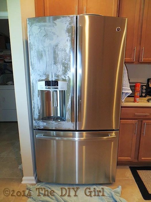 The DIY Girl's Fridge, with one fridge and freezer door gleaming with shine, while the other fridge door is covered in dried Pledge.