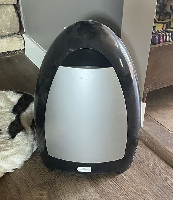 a reviewer’s black and silver touchless vacuum cleaner