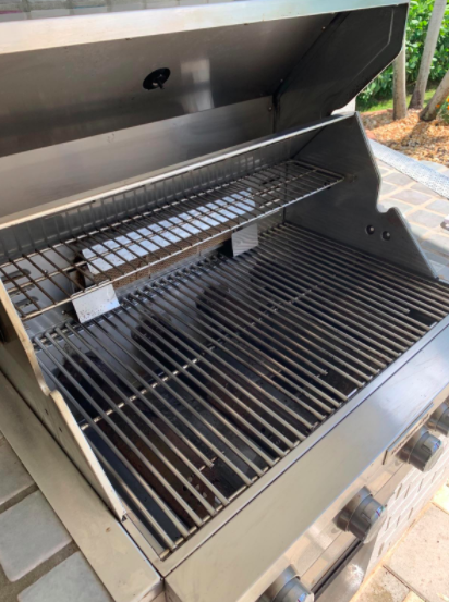 The same grill, now free of grime and gleaming after using the grill cleaner