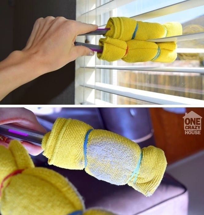 A close-up of a blogger's hand wiping down blinds with the tool, showing all the dust it has collected.