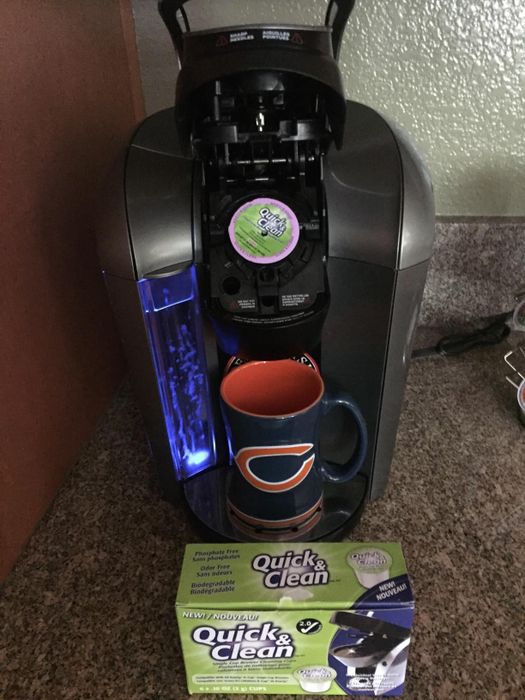 image from a reviewer showing a cleaning K-Cup inside their Keurig with the box of pods nearby