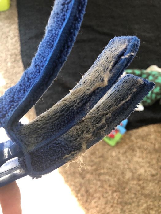 A reviewer's photo showing the dust collected by the brush after cleaning the blinds