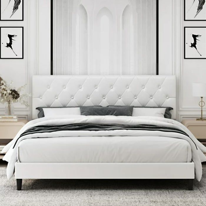 white faux leather upholstered bed