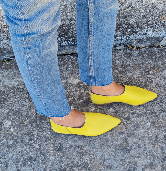 reviewer wearing the bright yellow loafers