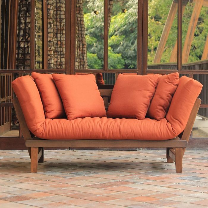 a natural brown loveseat placed on a patio outdoors
