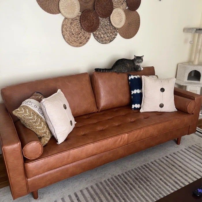 A reviewer photo showcasing the stylish couch in a cozy living space.