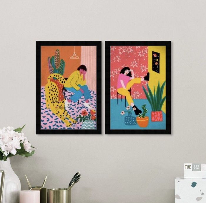 two vibrant and colorful art prints displayed on a beige wall