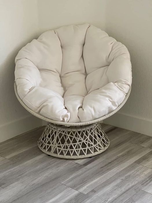 Reviewer image of a white papasan chair with a white wicker base and a tufted plush cushion in front of a white wall