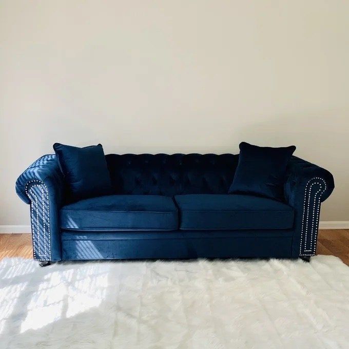 a navy blue sofa placed elegantly in a living room