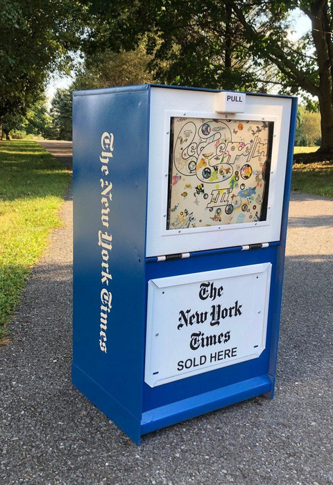 A refurbished New York Times newspaper box holding a Led Zeppelin record