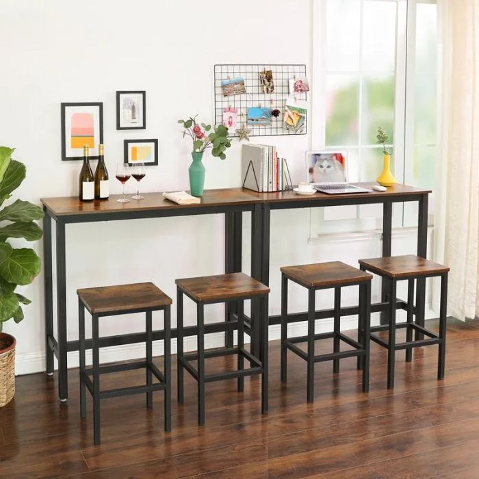 two faux wood-topped tables with black metal legs and four matching stools