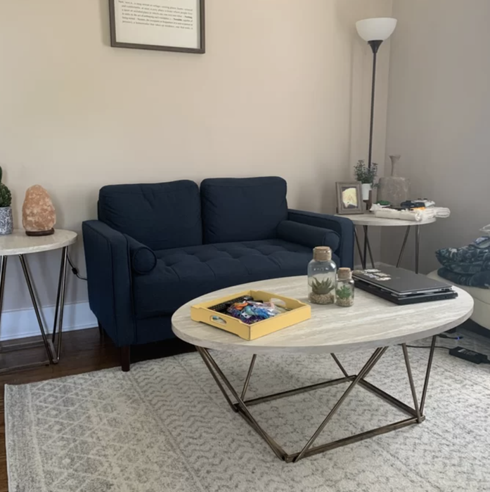 the blue loveseat placed in a living room