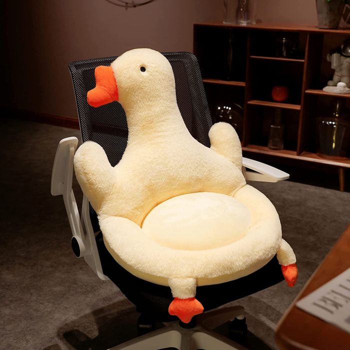 A large duck-shaped cushion on a computer chair