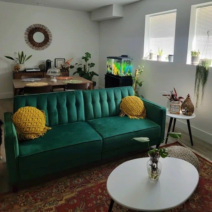 an emerald green sleeper sofa in a stylish living room space