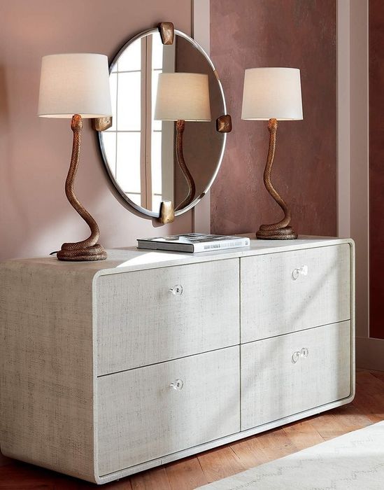 Two snake-themed lamps sitting on a dresser
