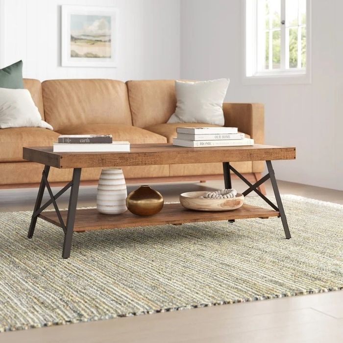 A brown wooden coffee table with a storage shelf