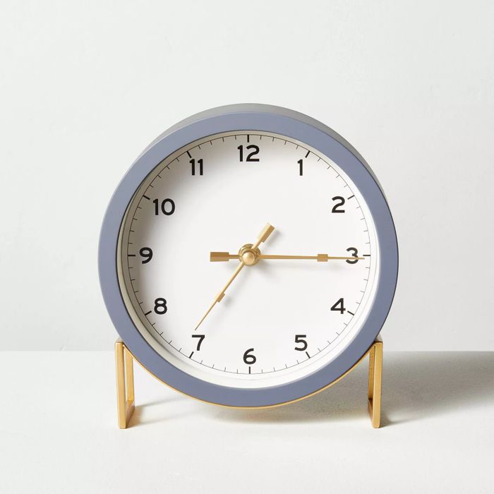 The round clock in a stylish gray and brass combination
