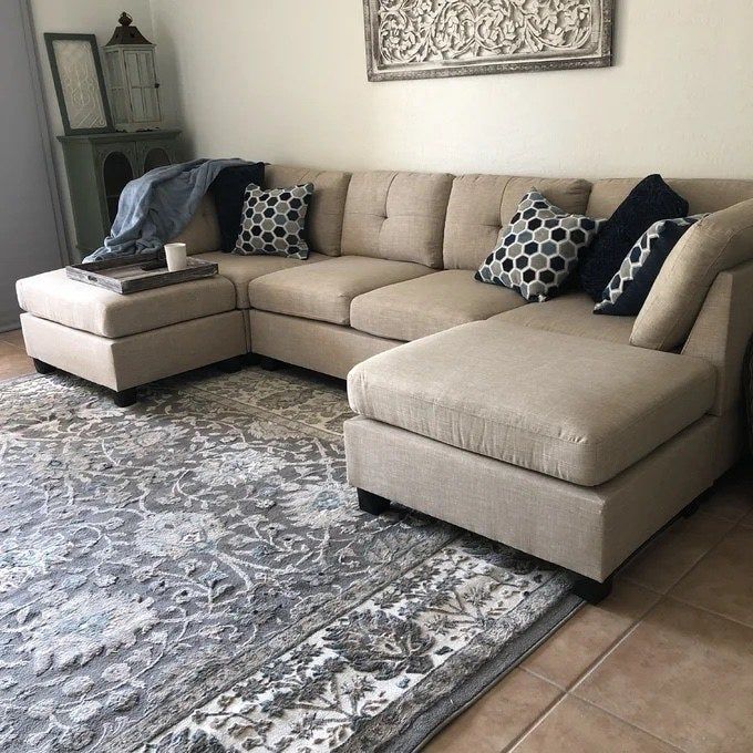 an almond-colored polyester sectional placed in a cozy living room