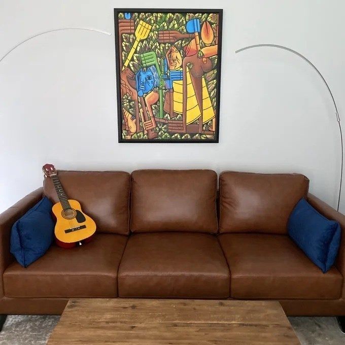 a reviewer's photo showcasing the leather sofa