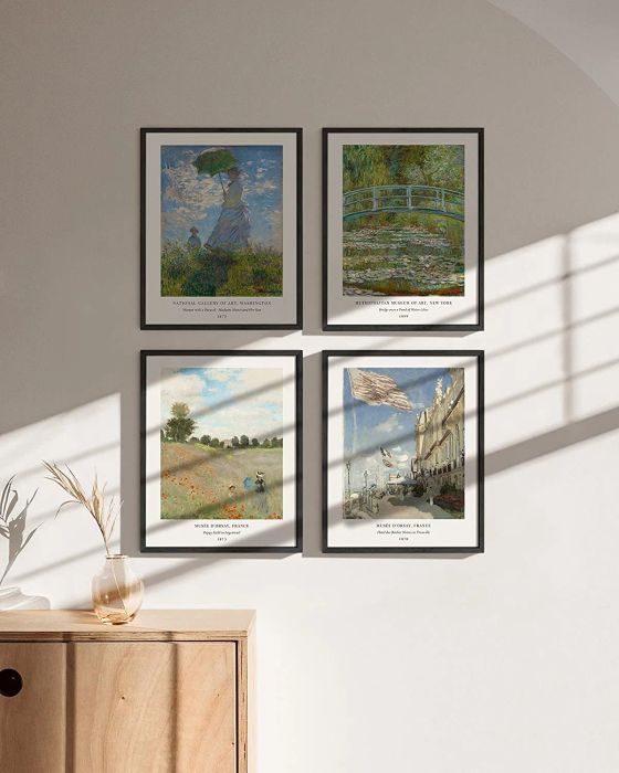 A collection of four framed posters showcasing Monet's art, hanging on a pristine white wall.