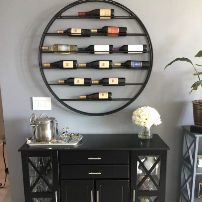 the wine rack on a reviewer’s wall filled with bottles of wine