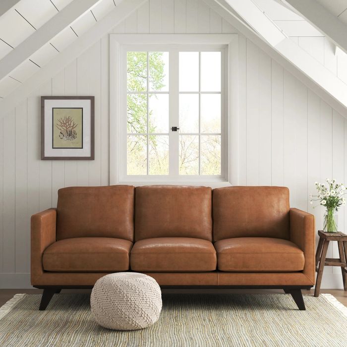 a camel-toned leather sofa tucked in a cozy corner