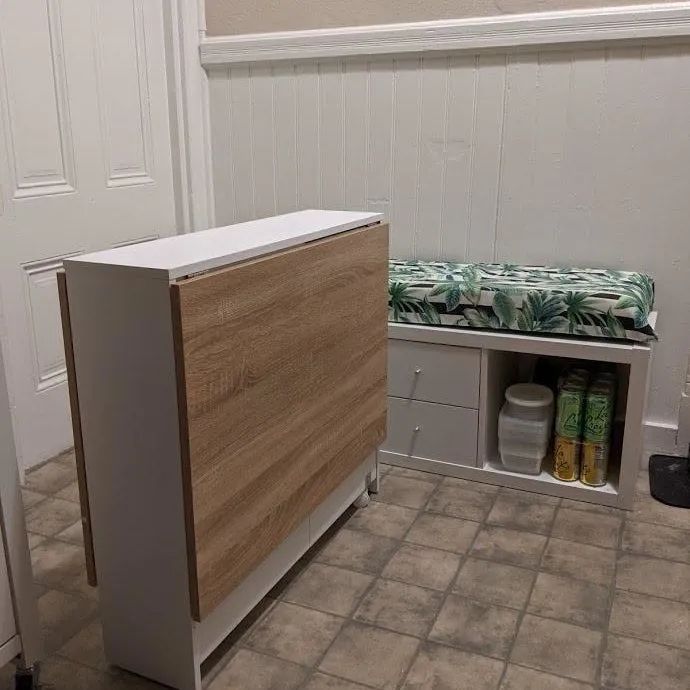 A reviewer's image showing the table neatly folded up, saving space when not in use.
