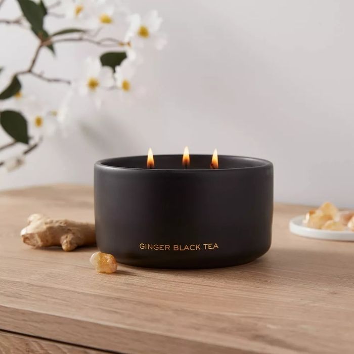 A black candle labeled 