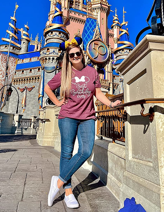 reviewer stepping out in white slip-ons at Disney