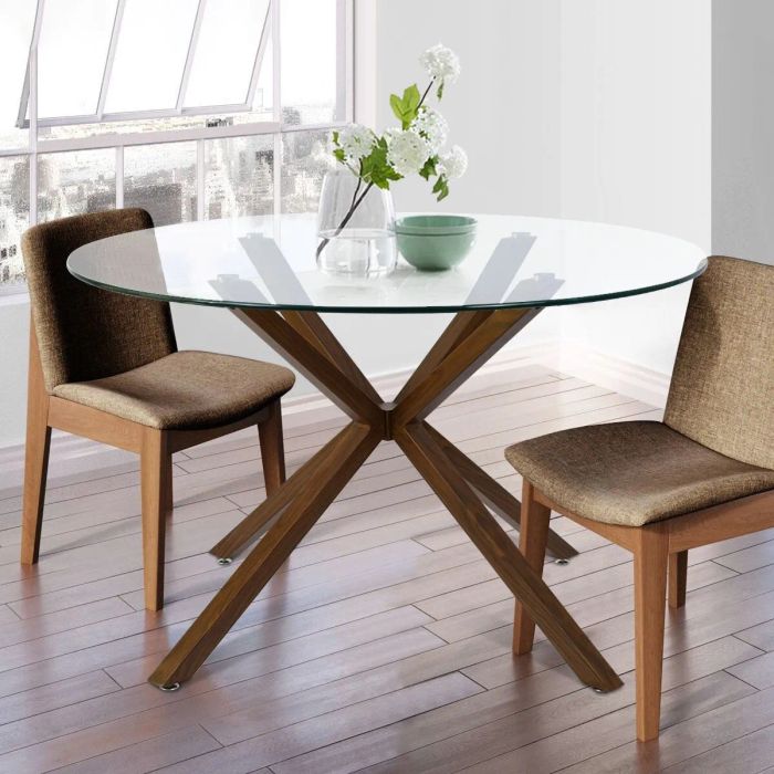 a round glass-topped table with faux wood legs, surrounded by two chairs