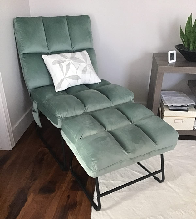 Reviewer image of the product in light green featuring a small hanging side pocket, paired with a white and gray throw pillow