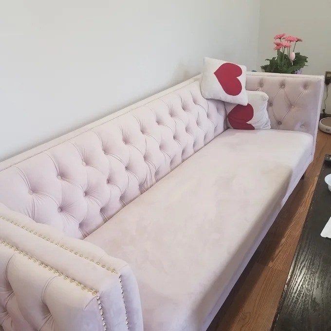 A reviewer’s close-up photo of the pink couch.