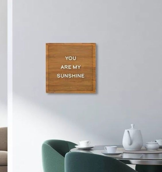 the wooden letter board with white letters displayed on a living room wall
