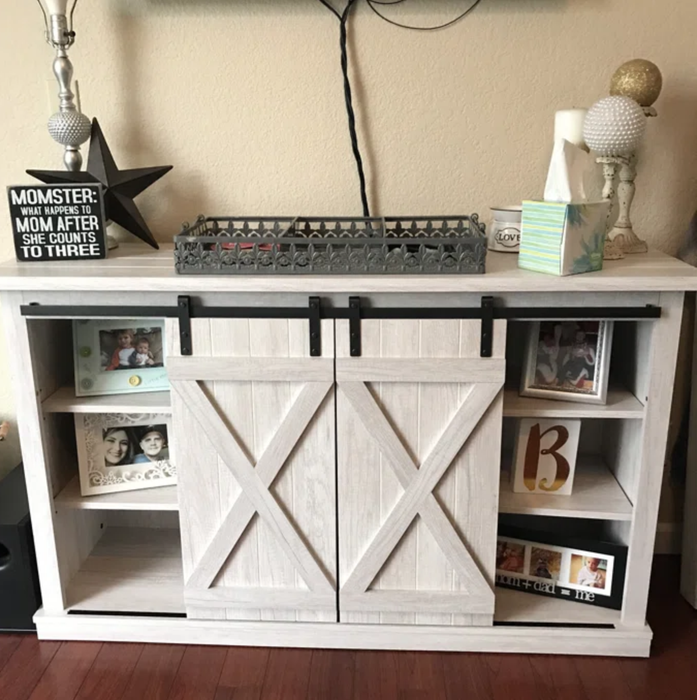 the grey TV stand decorated with various items