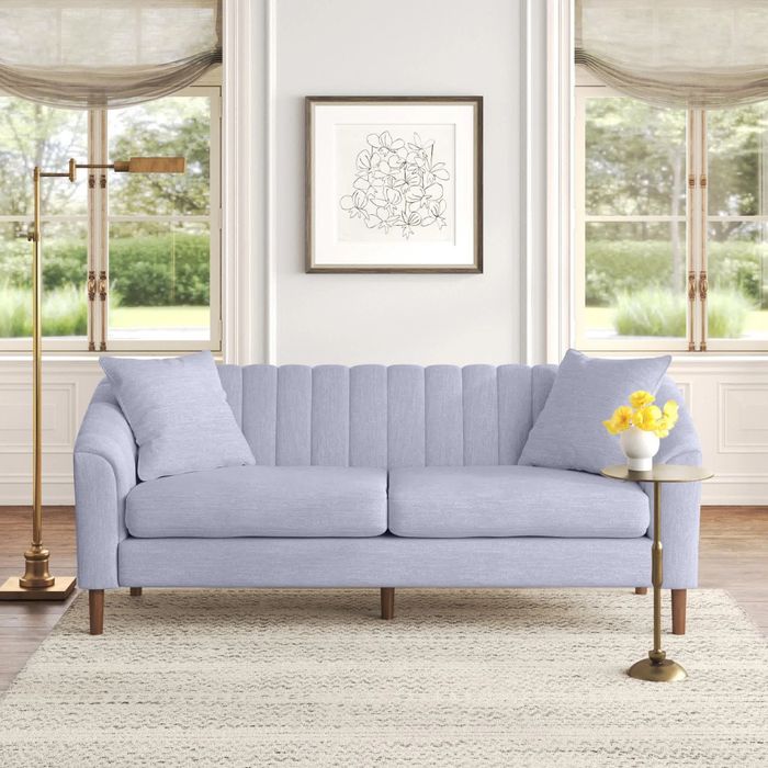 a cloud gray sofa in a bright living room with wide windows
