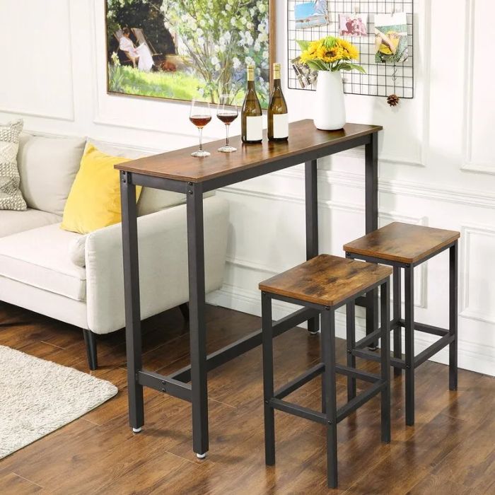 a faux wood-topped table with black metal legs and two matching stools