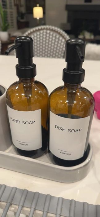 Two elegant brown pump bottles with labels.