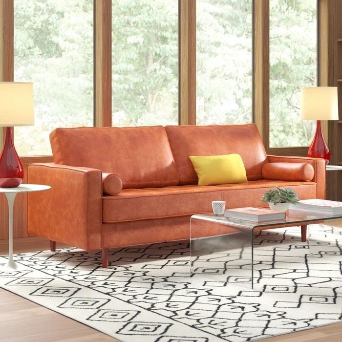 a caramel-colored leather sofa in a sleek, modern room