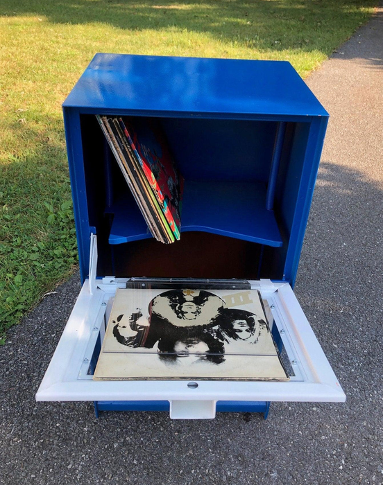 An open stand displaying records inside