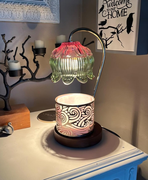 Green and pink warmer lamp with a candle placed beneath it