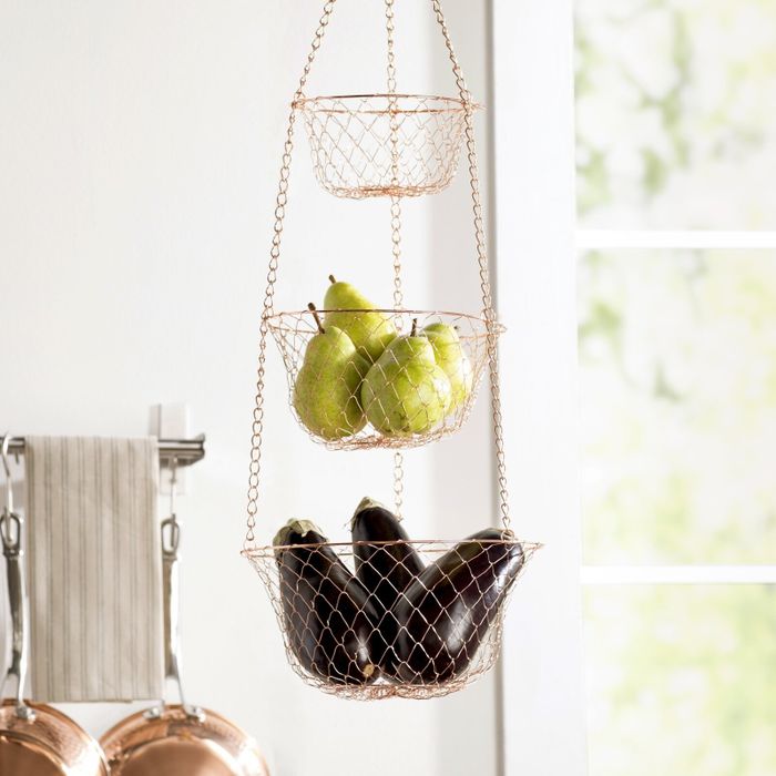 Three-tiered hanging fruit basket in a kitchen