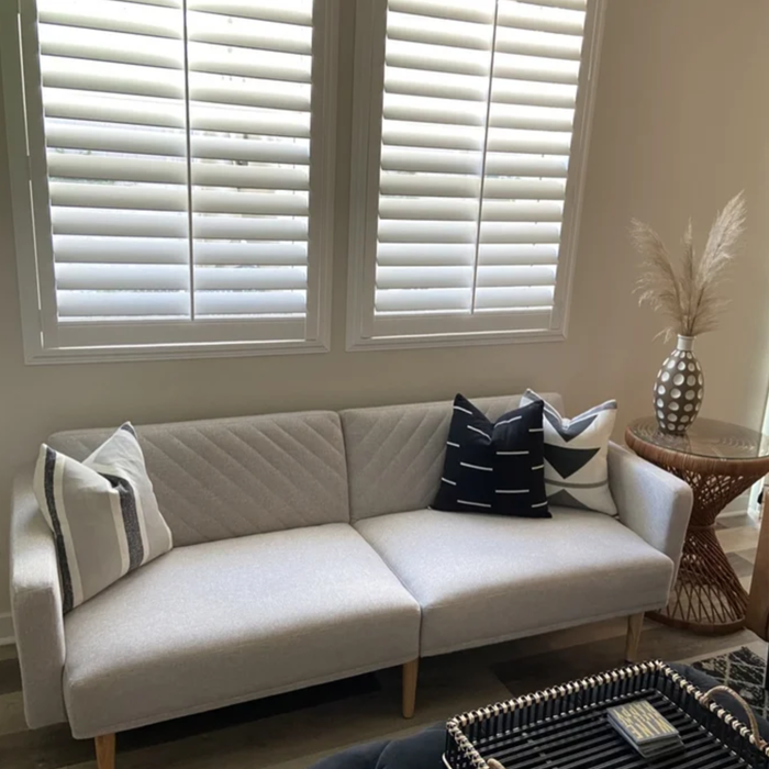 The gray sofa placed in a room