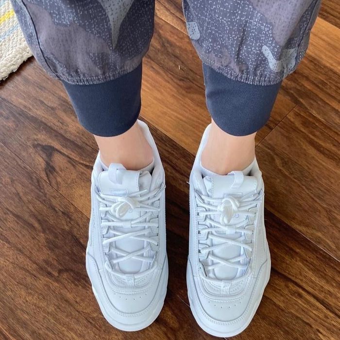 overhead view of reviewer's feet in white platform sneakers