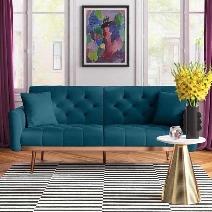 a stylish upholstered sleeper sofa in a modern living room setup