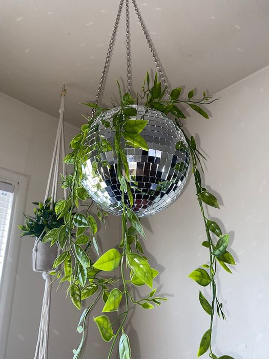 A different reviewer's disco ball planter holding a pothos plant.