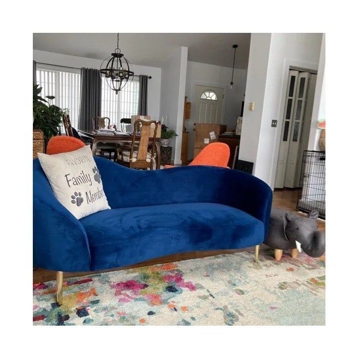 a navy blue upholstered sofa in a modern living room