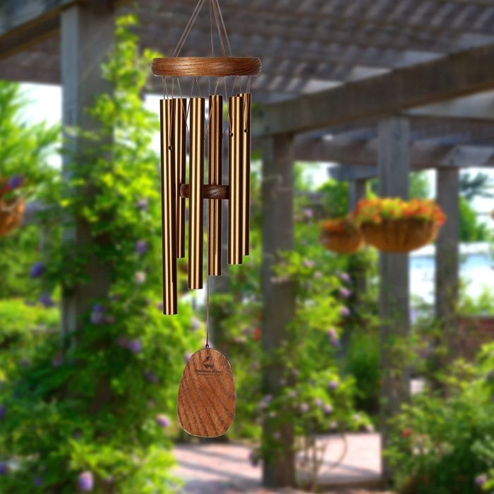 The wind chime gently swaying in a serene garden setting.