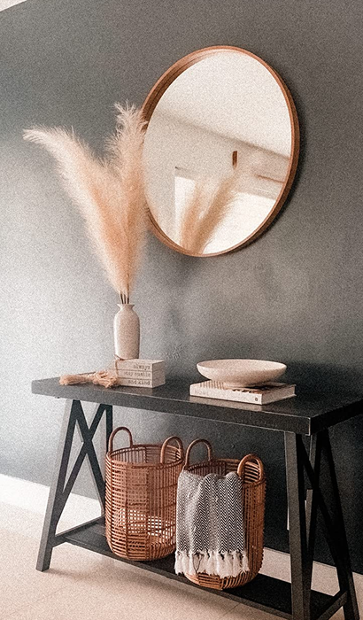 A reviewer's pampas grass arranged in a vase beside a mirror