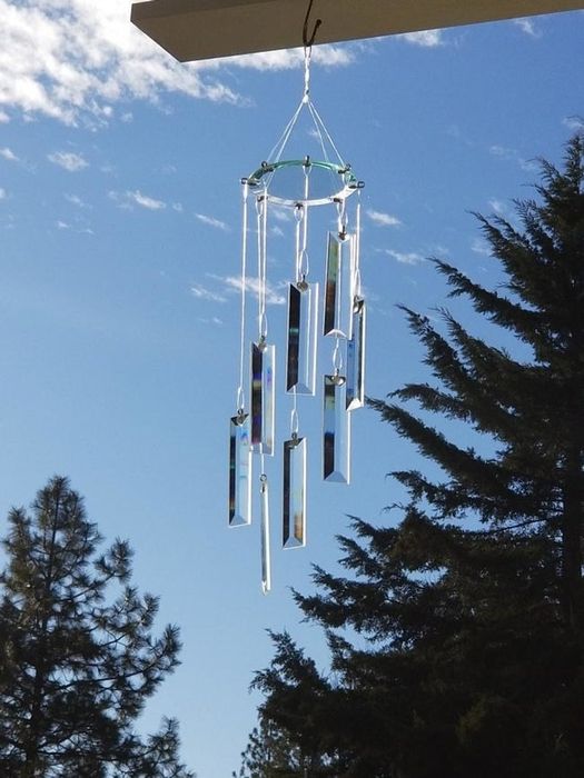 Glass wind chime hanging gracefully from a tree